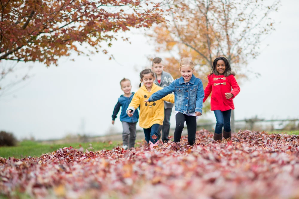 children running in fall leaves2-603152092